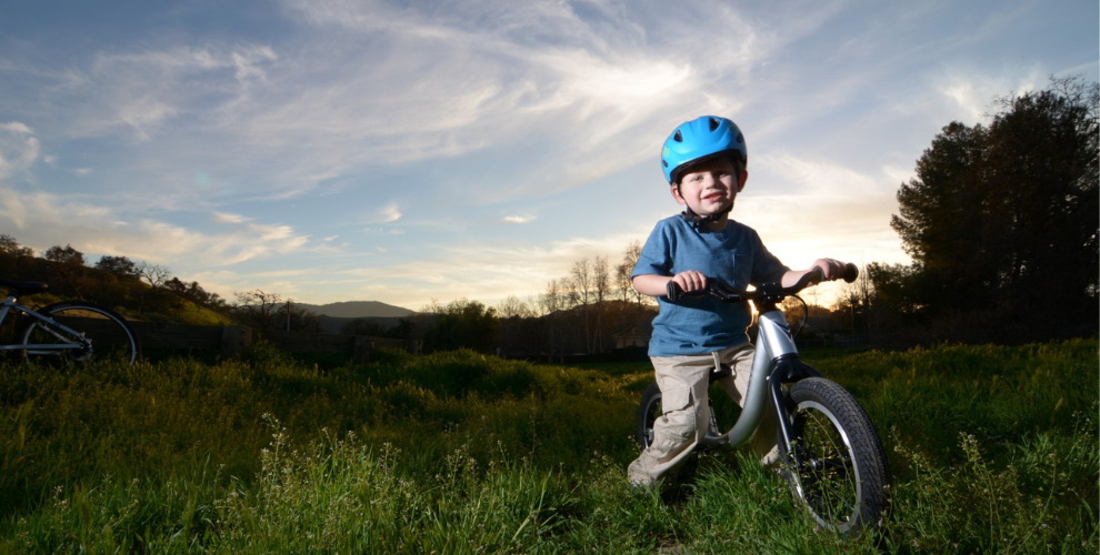 Little boy riding bike online